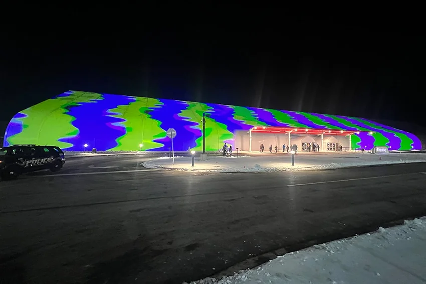 The Temporary by American Place illuminated with colorful exterior lighting at night