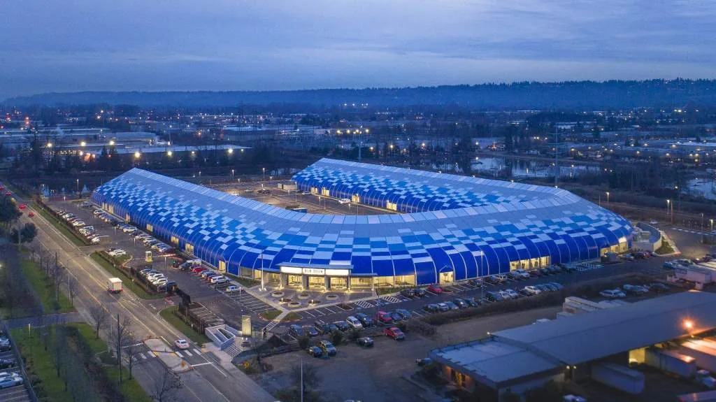 Aerial view of Blue Origin’s blue-roofed facility at dusk
