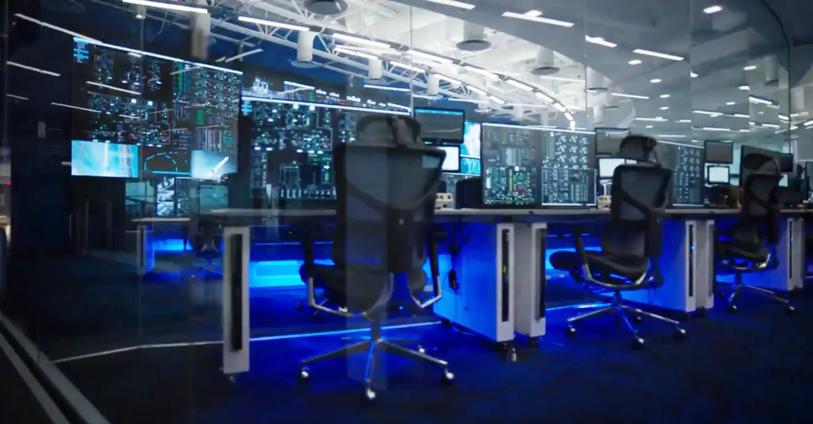Computer workstations and display screens in a Blue Origin control room