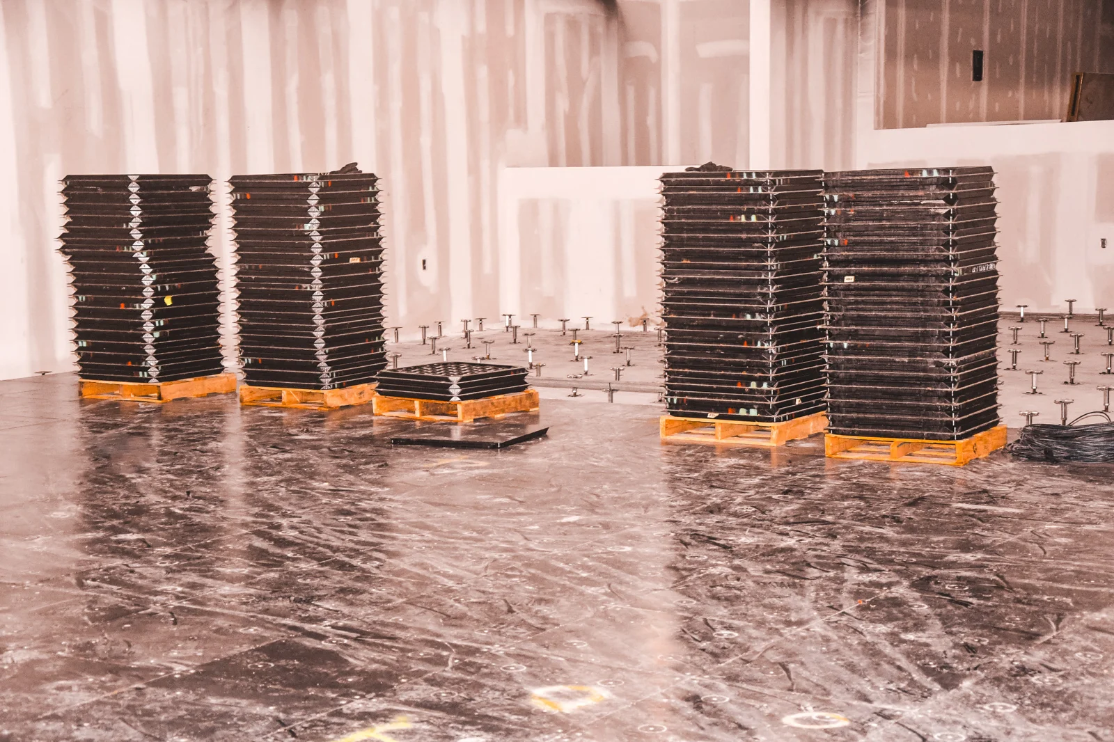 Raised floor panels staged on pallets with pedestals in the background at Coyote Valley Casino