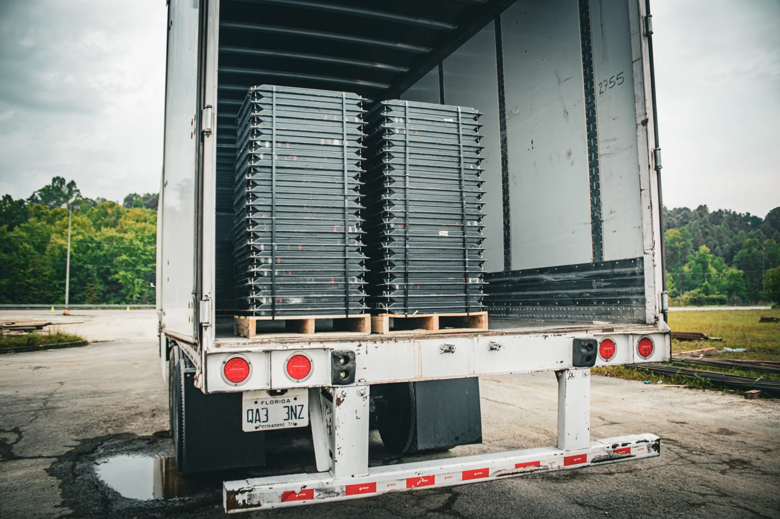 Raised floor panels stacked inside a delivery trailer