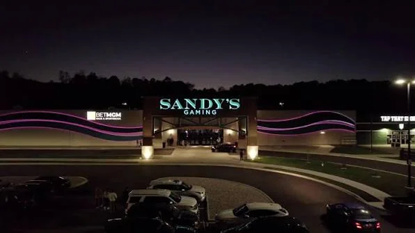 Sandy’s Racing & Gaming exterior and parking area at night