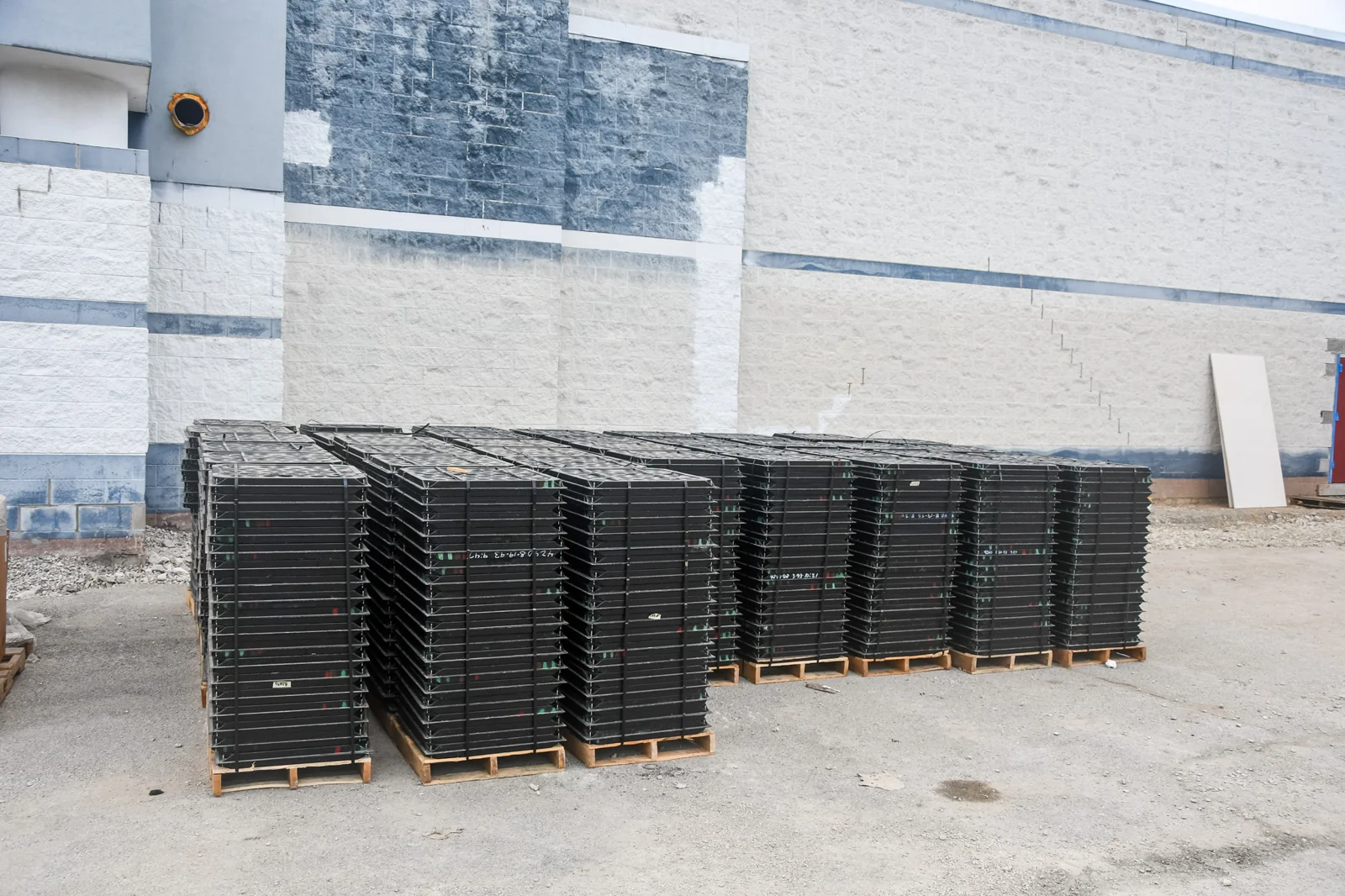 Pallets of bare raised floor panels staged for installation