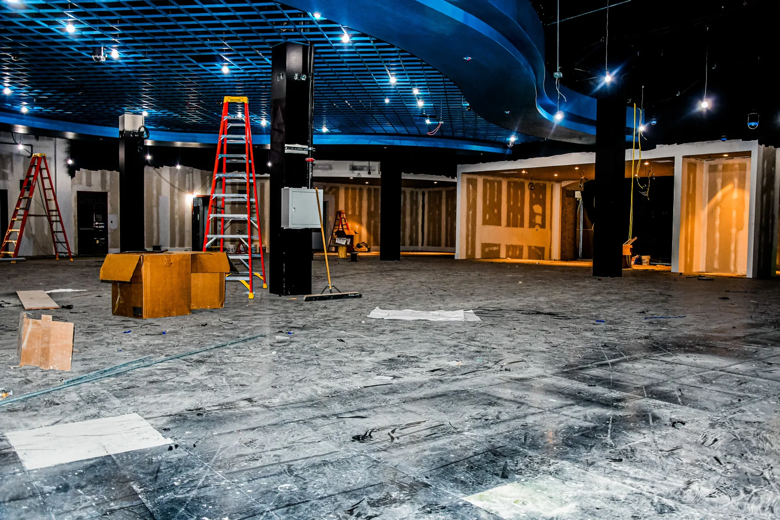 Bare raised floor panels installed across the gaming area during construction