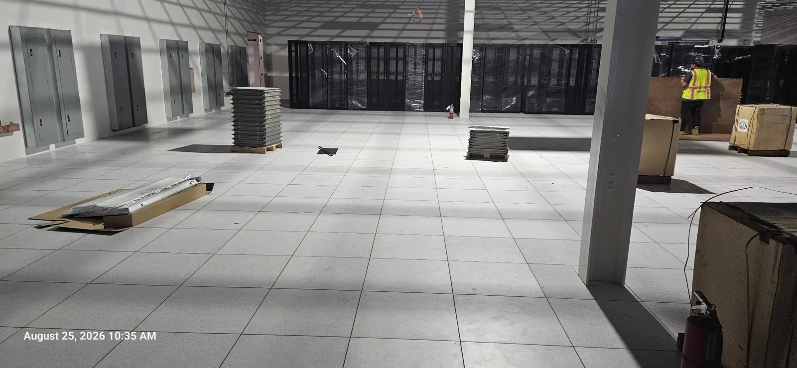 Wide view of the Vesgro data center raised floor with materials staged