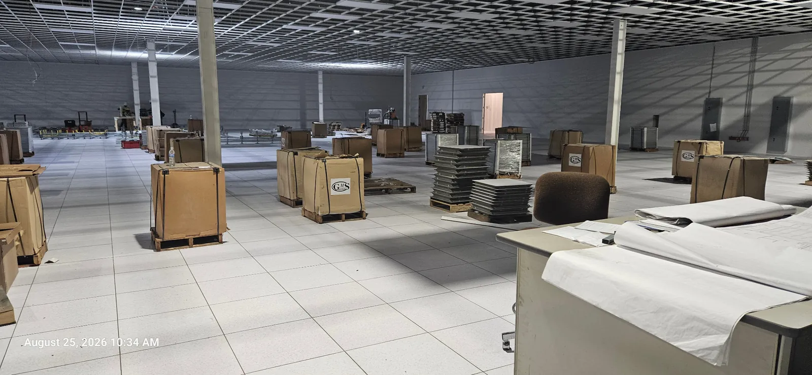 Wide view of the data center floor with equipment and project materials
